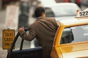 Passenger getting into taxicab he found through our transportation services